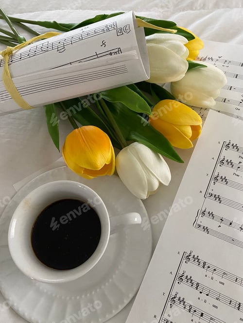 Preview: Music sheets on cozy bed with spring tulips and coffee