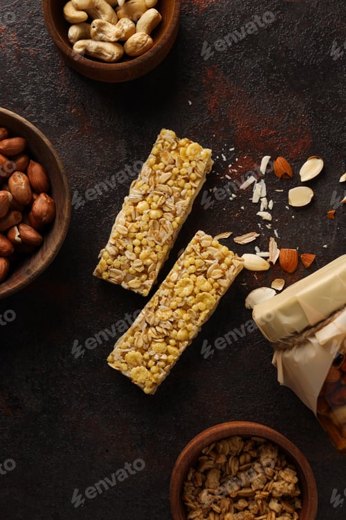 Preview: Granola bars with nuts in a bowl on a dark background