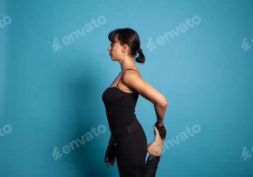 Preview: Active trainer stretching leg muscles during fitness workout