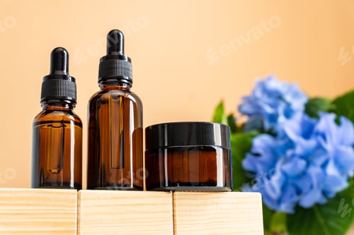 Preview: Natural essential oil, serum and cream in a brown glass bottles on a wooden podium. Alternative medi