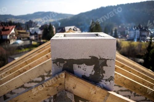 Preview: Close-up detail of roof frame of rough wooden lumber beams and chimney made of foam insulation