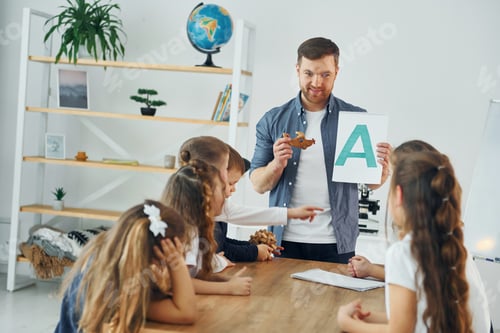 Preview: Learn new A letter. Group of children students in class at school with teacher