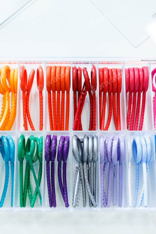 Preview: Colored elastic orthodontic bands for braces. Dentistry. Orthodontic treatment of teeth.