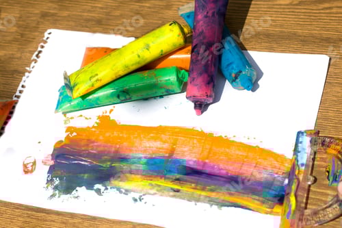 Preview: Top view of colorful watercolor paint in plastic tubes on white paper background, art and creativity