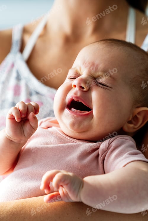 Preview: Portrait of a happy mother with her tired newborn baby. Family love concept