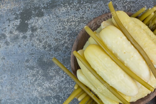 Preview: Delicious pickled cucumbers on wooden board