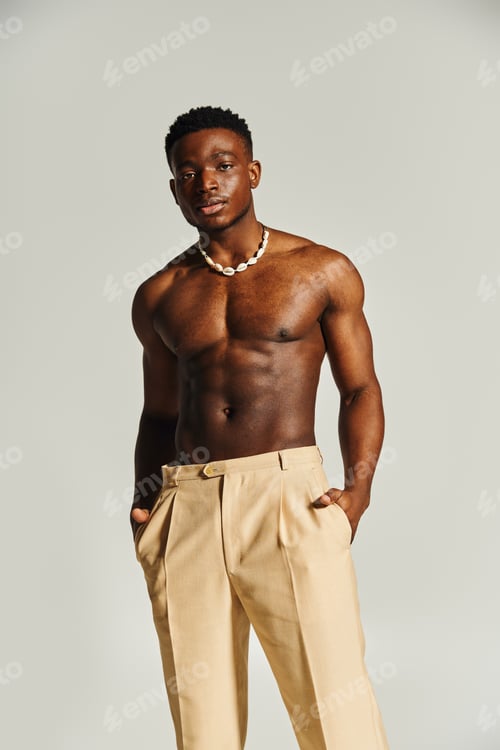 Preview: Confident young man showcasing style and charisma in a minimalist setting