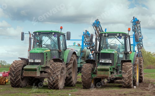 Preview: Two Farm Tractors Parked in Field on Cloudy Day