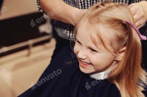 Preview: Little Girl Enjoys Her First Haircut Experience in a Cozy Barbershop Atmosphere