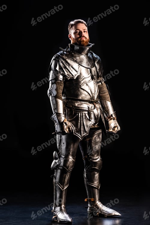 Preview: handsome knight in armor looking at camera on black background