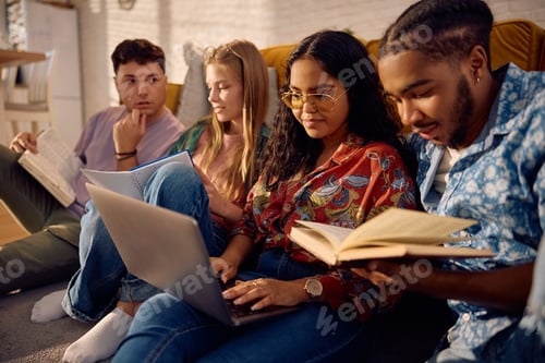 Preview: Group of university friends studying together at home.