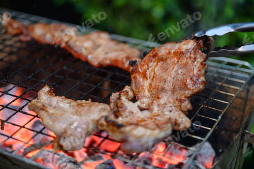 Preview: Grilled marinated pork on charcoal grill in dinner