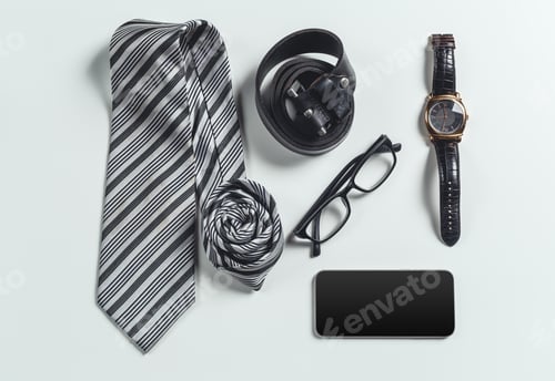 Preview: Items arranged on a table showing a tie, glasses, a watch, a phone, and a belt