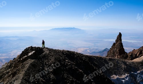 Preview: Hiker ascending top of volcanic mountain