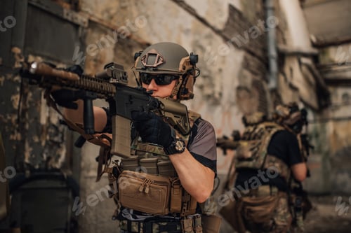 Preview: Brave soldier with sniper rifle shooting at enemy at crashed building.