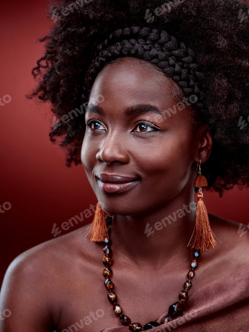Preview: Naturally beautiful. Cropped shot of a beautiful young woman posing against a red background.
