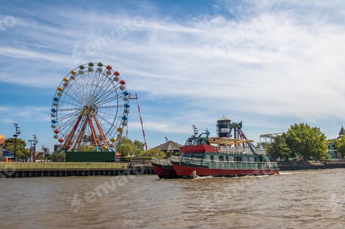 Preview: Ferris Wheel, amusement park and ferry boat in Lujan River - Tigre, Buenos Aires, Argentina