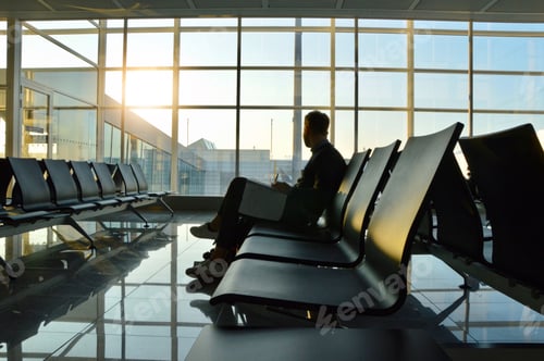 Preview: Photo of a young man waiting at an airport