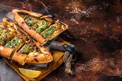 Preview: Traditional Turkish baked pide, Middle Eastern snack. Turkish pizza. Dark background. Top view.