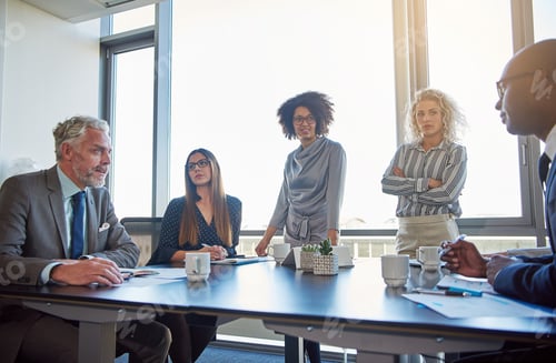 Preview: Executives talking business together in a modern office