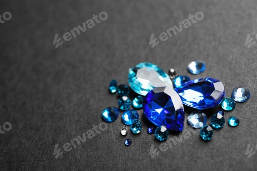 Preview: Pile of different beautiful gemstones on black background. Space for text