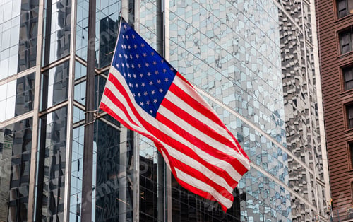 Preview: American flag in Chicago, Illinois downtown. Glass facade buildings background.