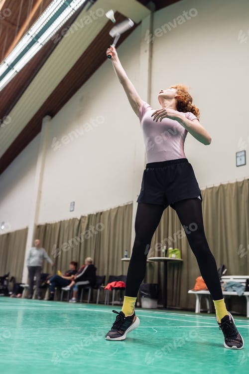 Preview: Indoor sports. People different ages play badminton on sports court indoors