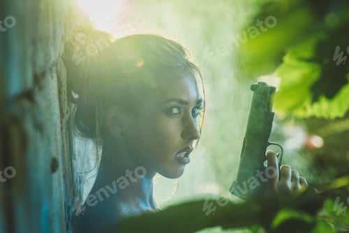 Preview: A Woman With a Gun Standing Next to a Brick Wall