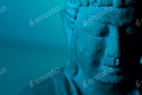 Preview: Closeup of a stone statue of Buddha under the moonlight