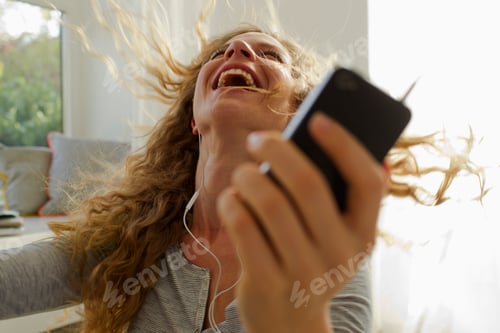 Preview: Woman dancing to music on smartphone