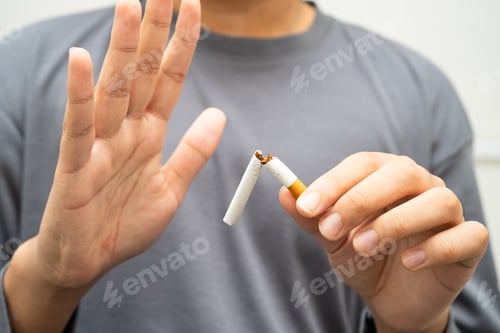 Preview: Quit smoking, Asian teenage man breaking destroy cigarette in hand.