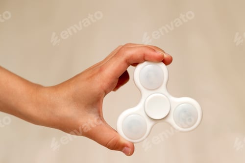 Preview: White fidget spinner toy in hand of a child
