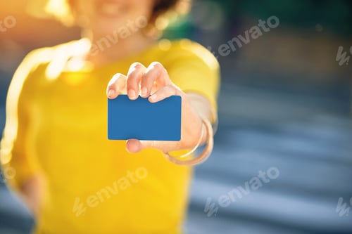 Preview: I prefer to pay with plastic. Shot of an unrecognizable young woman holding a credit card.