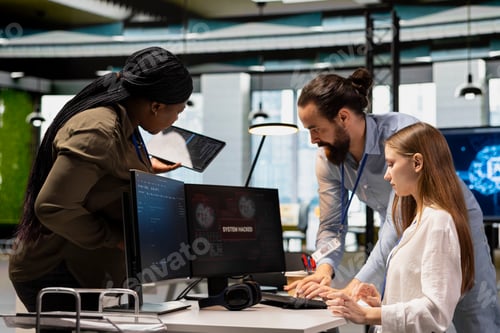 Preview: Young engineer blocking hacker in office, requesting help from IT experts