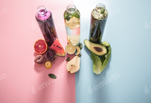Preview: Glass bottles with natural drinks on a colored background