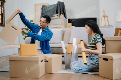 Preview: Young couple with big boxes moving into a new house, new apartment for couple