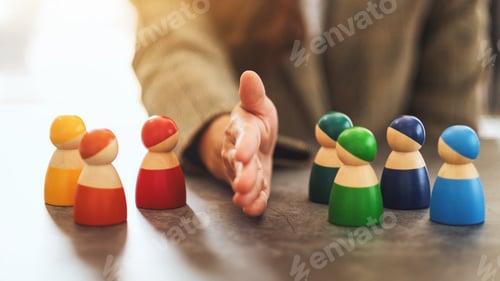 Preview: Concept image of a business woman separate wooden people into two group