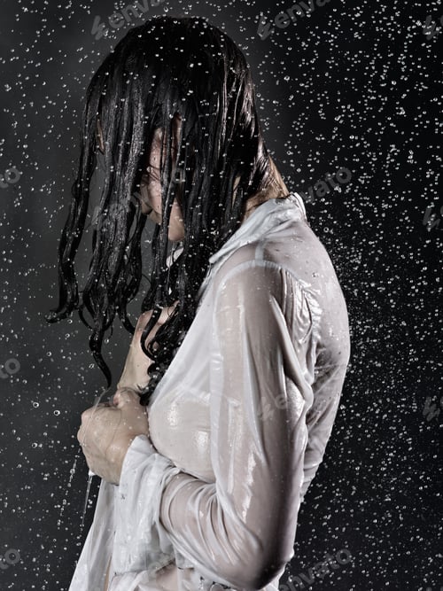 Preview: Side view of woman wearing white shirt drenched in rain