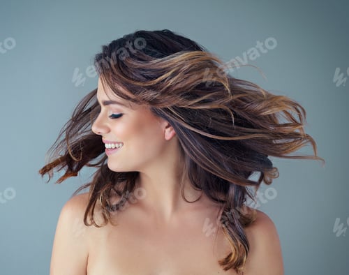 Preview: Cropped shot of a beautiful young woman posing against a grey background in the studio