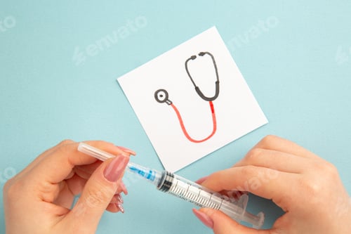 Preview: top view covid- related notes with female holding injection on blue background vaccine color lab