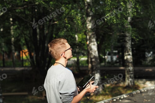 Preview: Pilot drone. A young man controls a drone. Photo and video aerial photography.