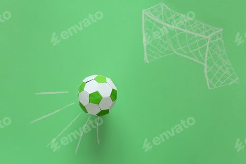 Preview: Paper soccer ball flying into goal painted by chalk on green background