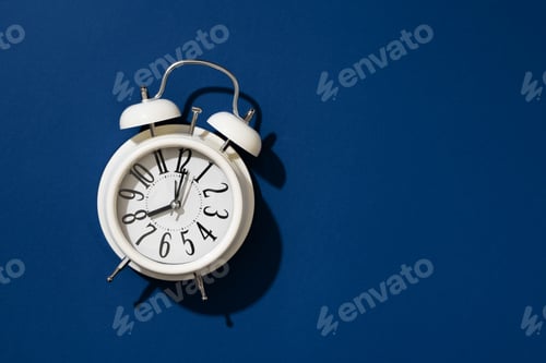Preview: White clock close up on blue background