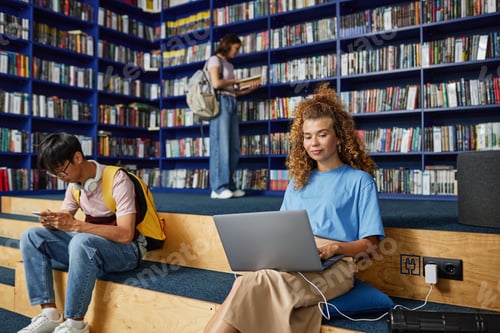Preview: Girl Using Laptop in Library