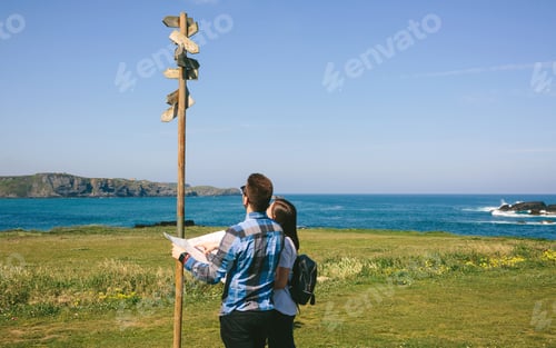 Preview: Couple looking a map and direction sign