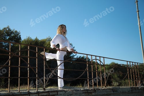 Preview: Ballerina Girl Wearing White Dress Practices Dance Poses Outside