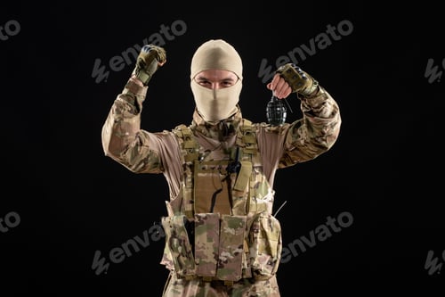 Preview: front view young soldier in uniform with grenade on a black background warrior tank israel