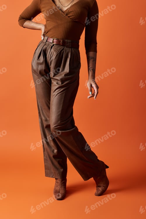 Preview: Confident young Black woman poses in a vibrant studio setting