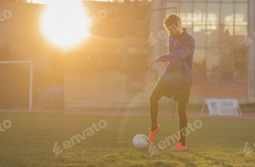 Preview: Young Football Player Shooting Soccer Ball. Grass Field Sun, Sunny.
