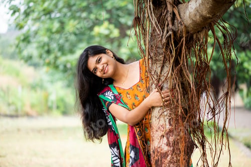 Preview: Happy woman near banyan tree